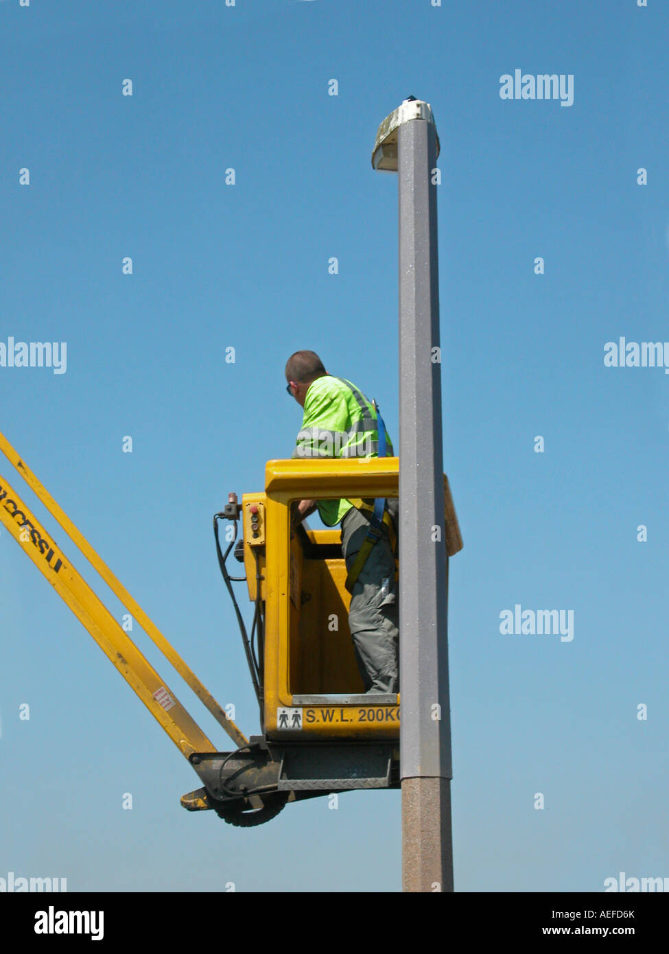 street lighting contractor vehicle in use with workman going up in