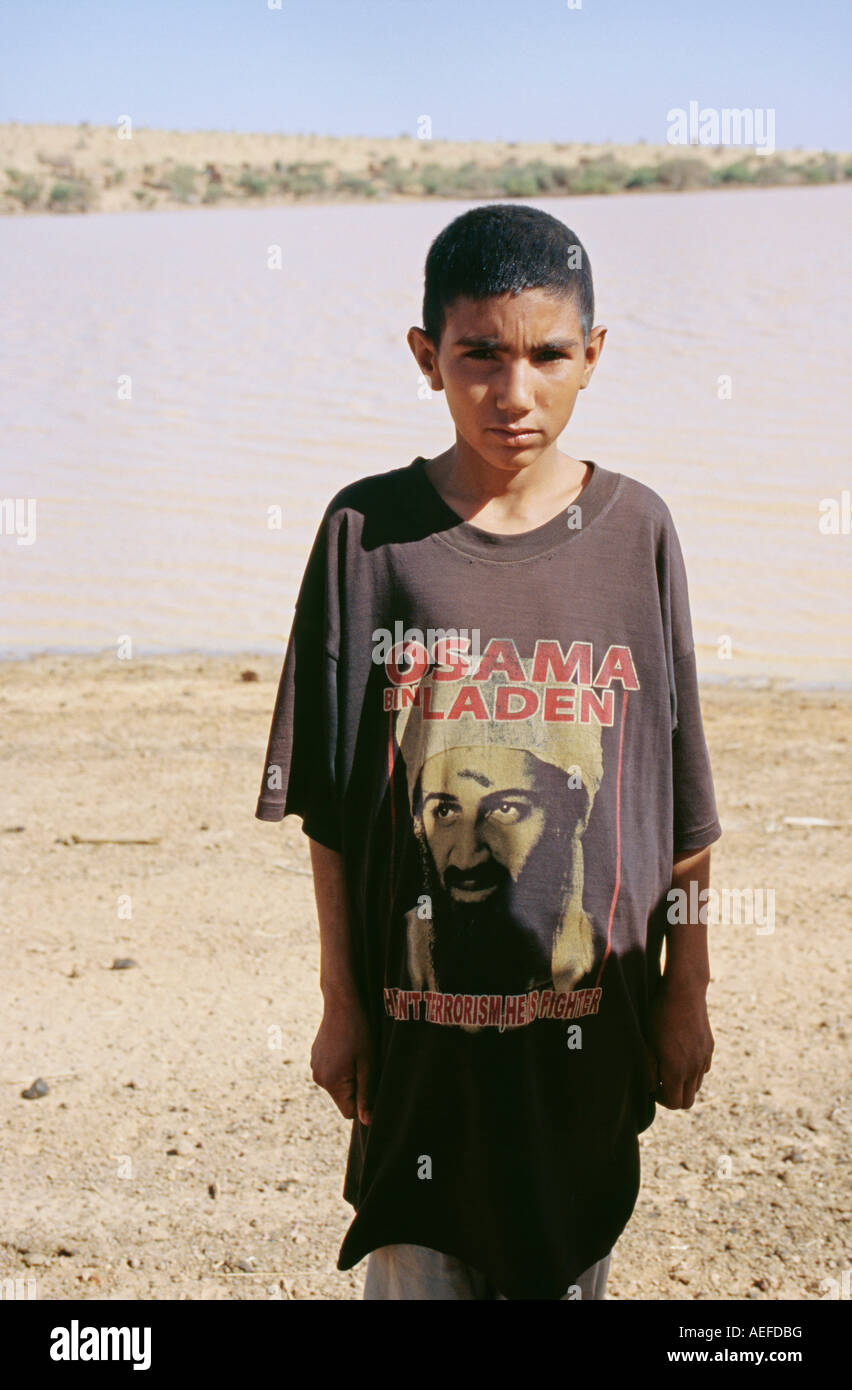 Mali. Ansongo. Boy from Tuareg tribe with T-shirt with image of Osama Bin Laden. Background:  Niger river. Stock Photo