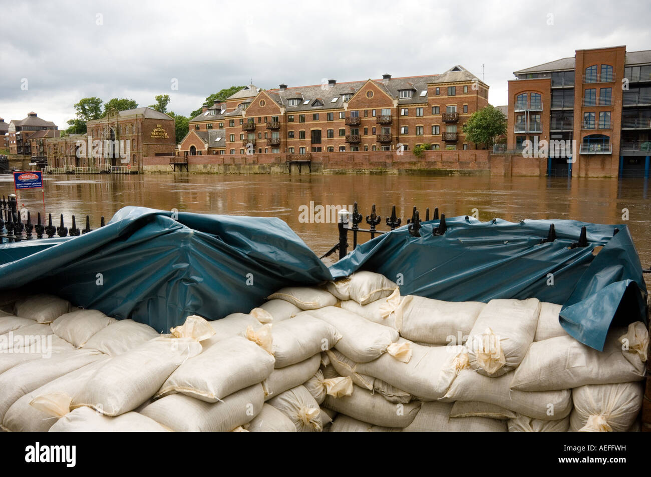 Sandbag wall at the side of the river Ouse, a temporary flood barrier