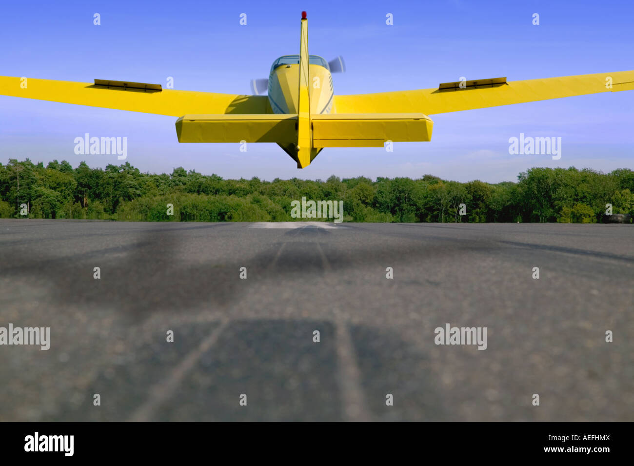 Light aircraft landing on a tarmac runway Stock Photo Alamy