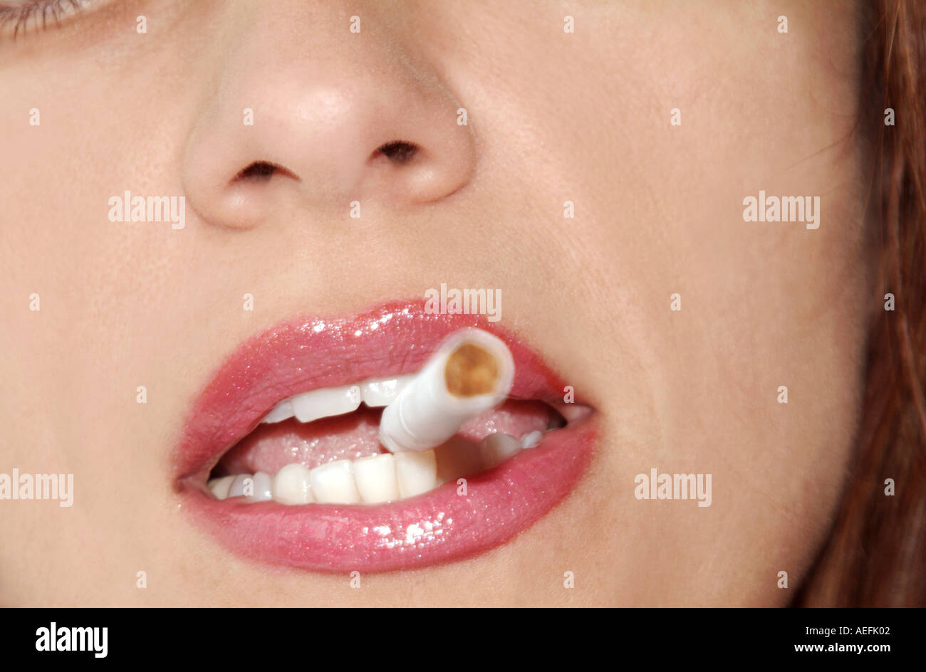 Woman with unlit cigarette in mouth Stock Photo Alamy