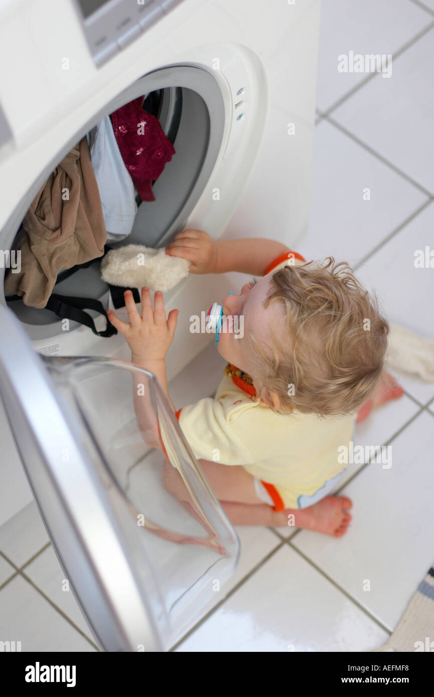 baby exploring washing machine Stock Photo Alamy