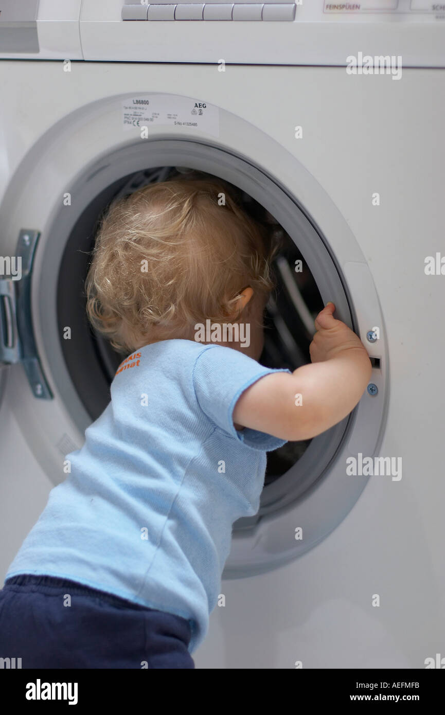 baby exploring washing machine Stock Photo - Alamy