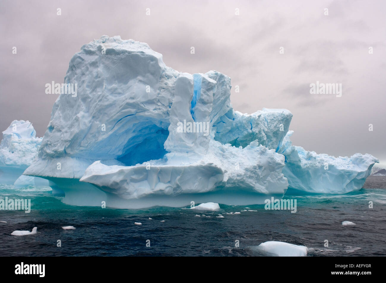 Arched Iceberg Floating Off The Western Antarctic Peninsula Antarctica arched-iceberg-floating-off-the-western-antarctic-peninsula-antarctica