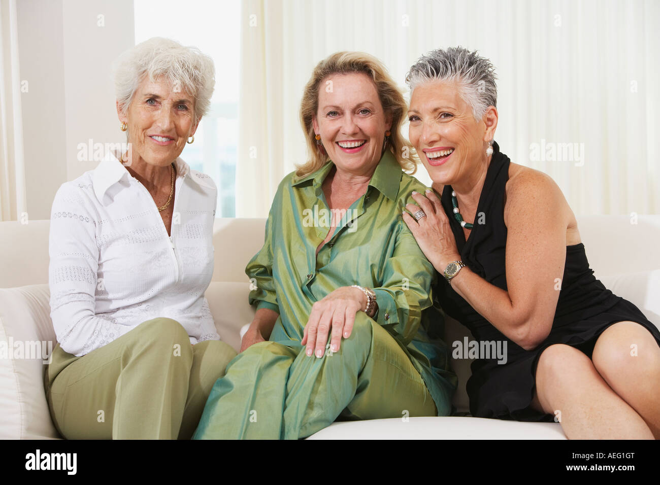 Three senior women sitting on sofa Stock Photo - Alamy