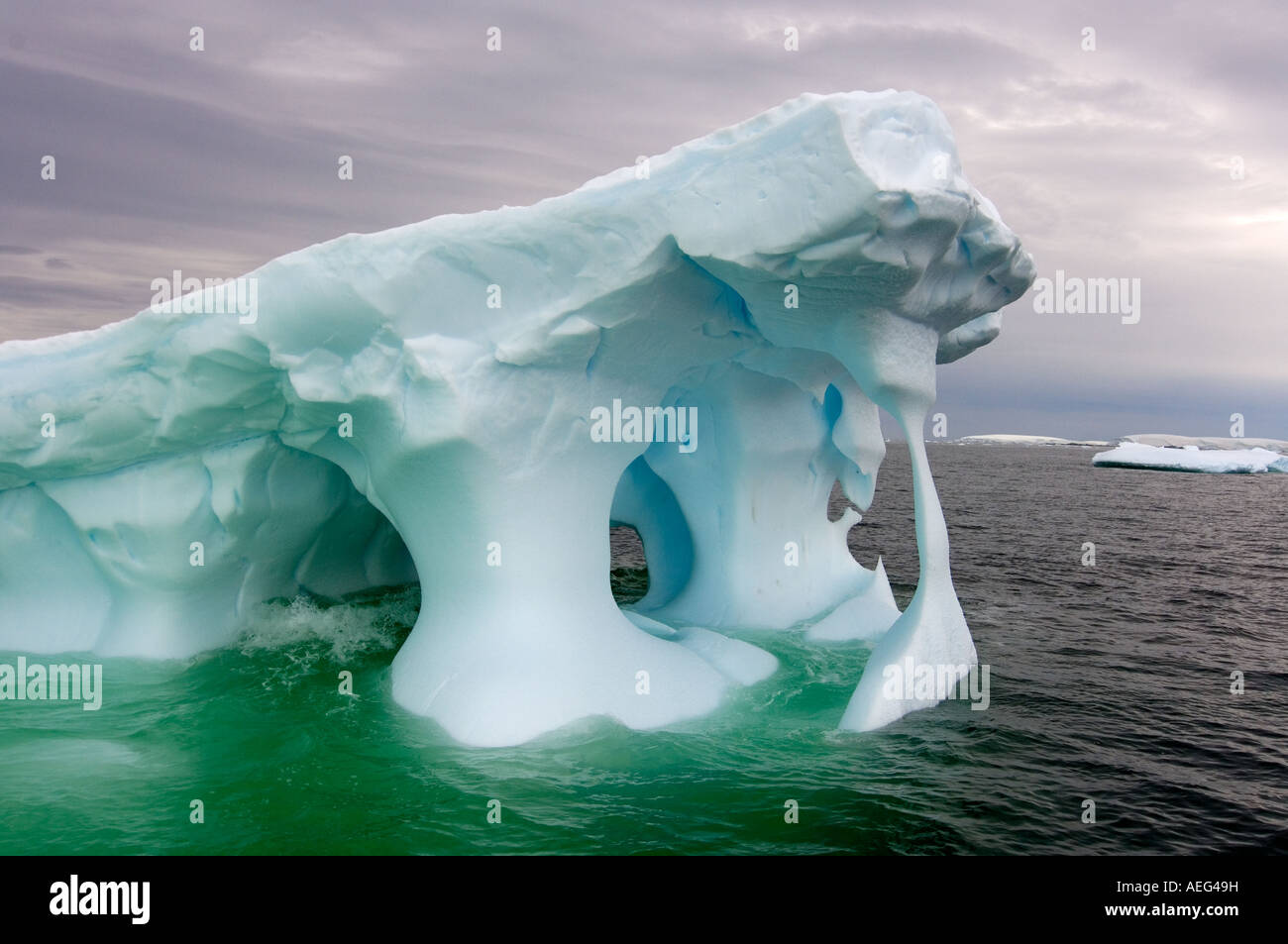 Arched Iceberg Floating Off The Western Antarctic Peninsula Antarctica arched-iceberg-floating-off-the-western-antarctic-peninsula-antarctica