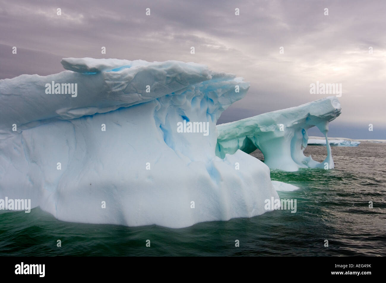 Arched Iceberg Floating Off The Western Antarctic Peninsula Antarctica arched-iceberg-floating-off-the-western-antarctic-peninsula-antarctica