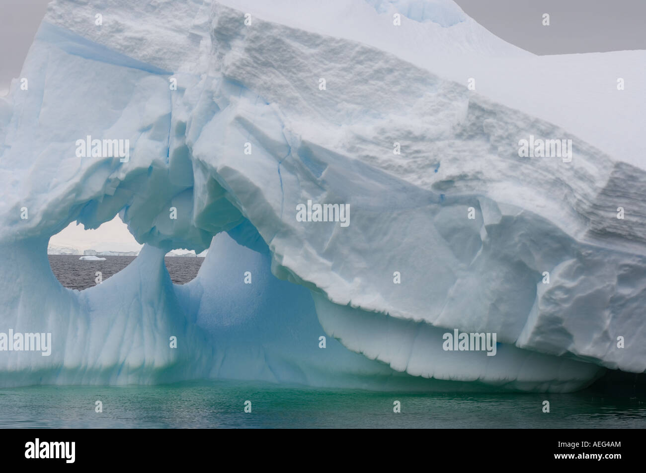 Arched Iceberg Floating Off The Western Antarctic Peninsula Antarctica arched-iceberg-floating-off-the-western-antarctic-peninsula-antarctica