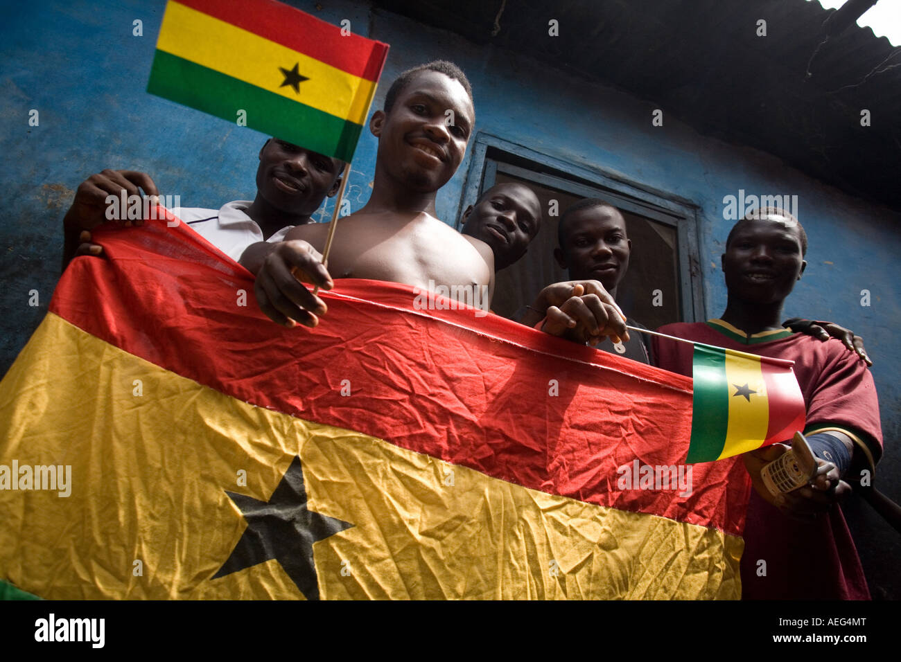 Young men holding Ghana flags Stock Photo