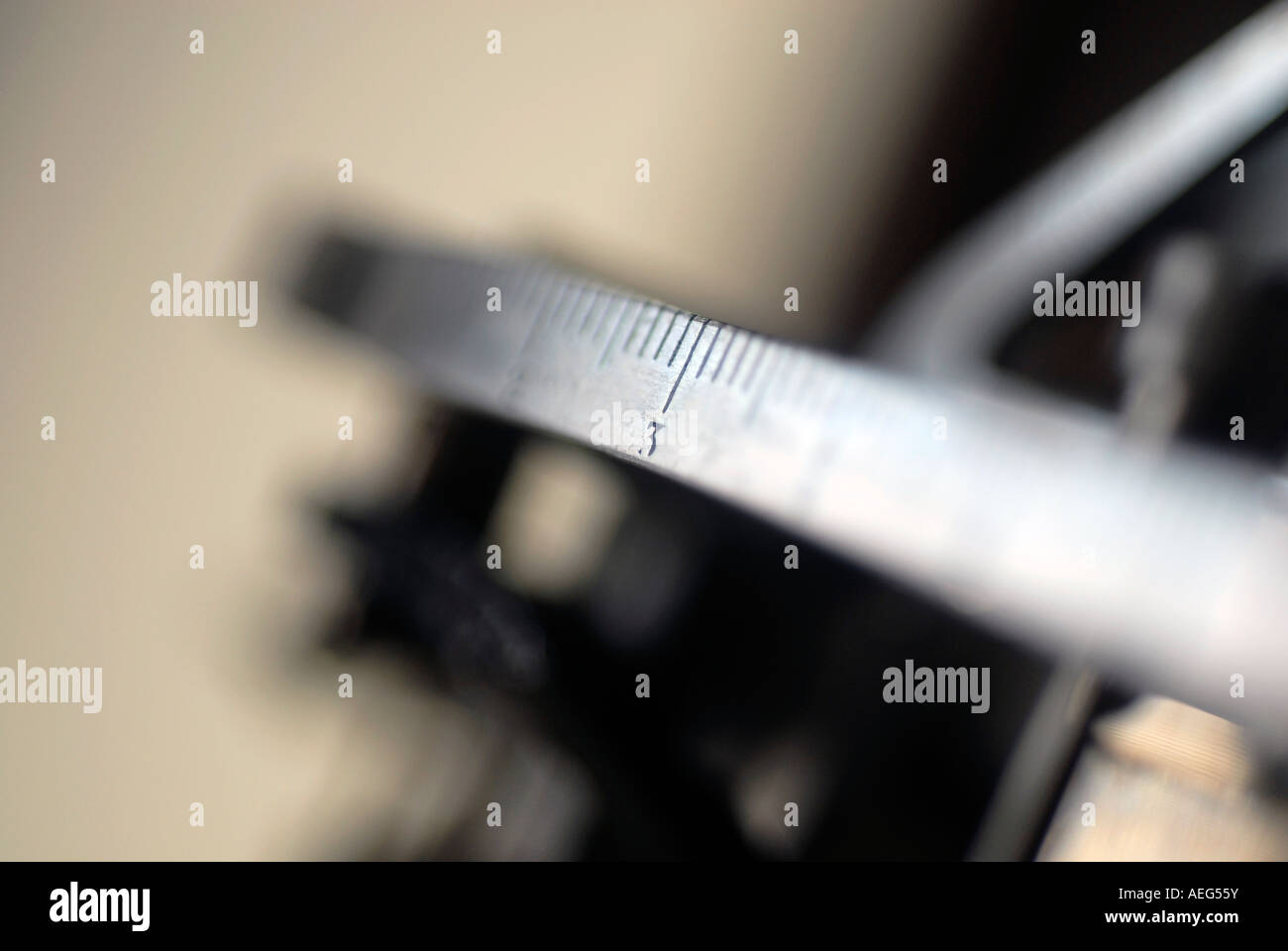 Slider of a mechanical balance scale marking number three Stock Photo