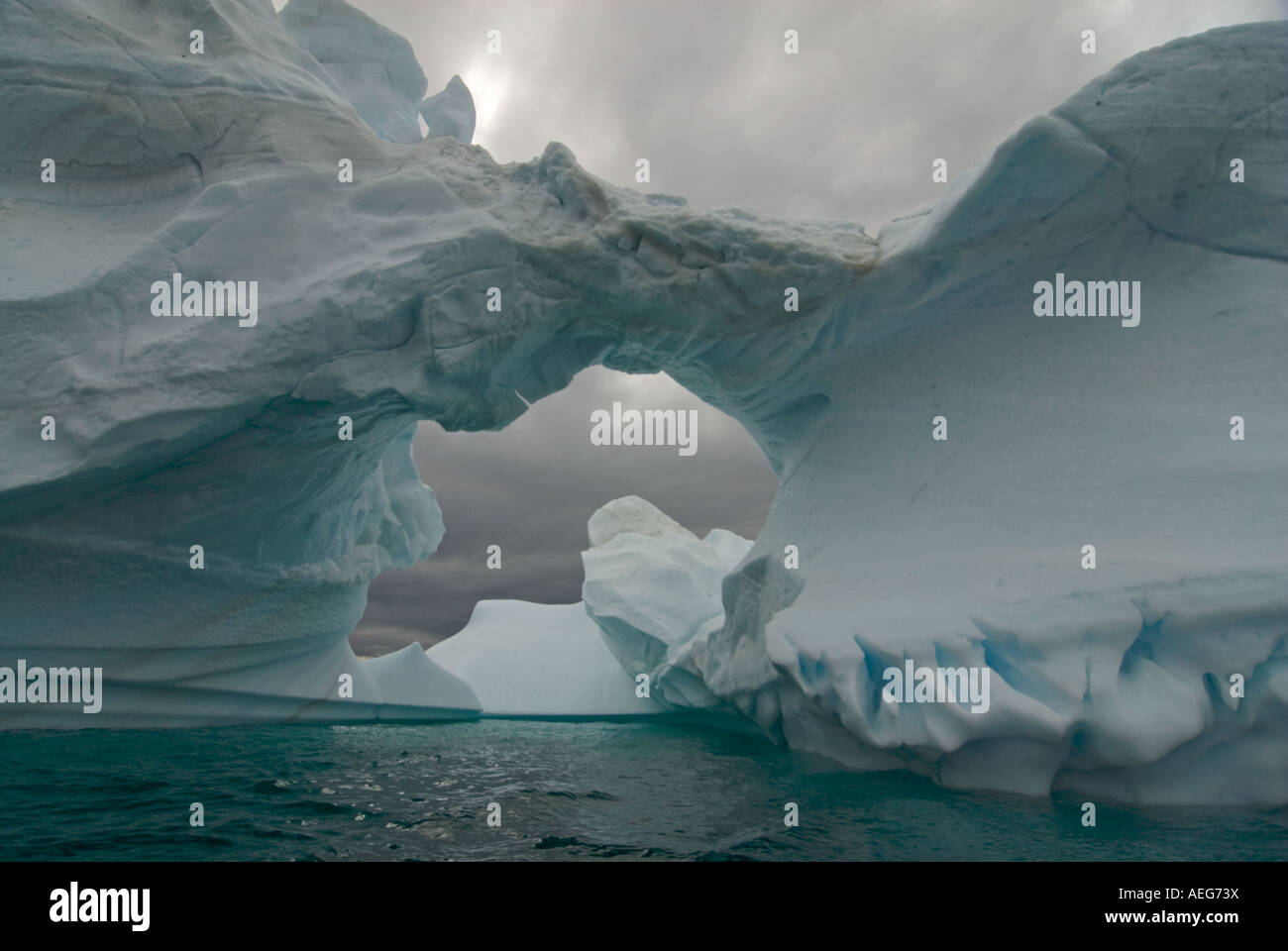 Arched Iceberg Floating Off The Western Antarctic Peninsula Antarctica arched-iceberg-floating-off-the-western-antarctic-peninsula-antarctica