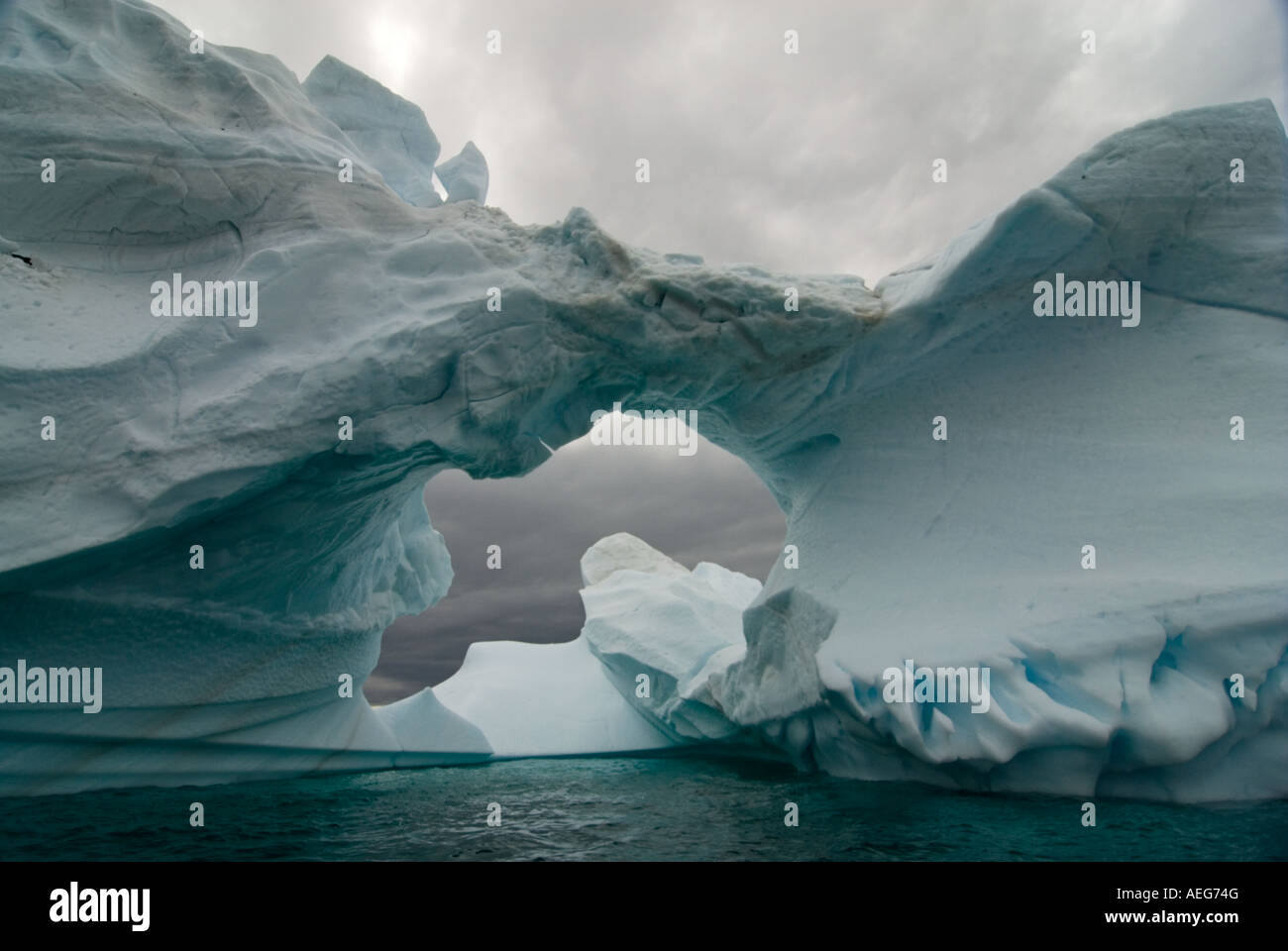 Arched Iceberg Floating Off The Western Antarctic Peninsula Antarctica arched-iceberg-floating-off-the-western-antarctic-peninsula-antarctica