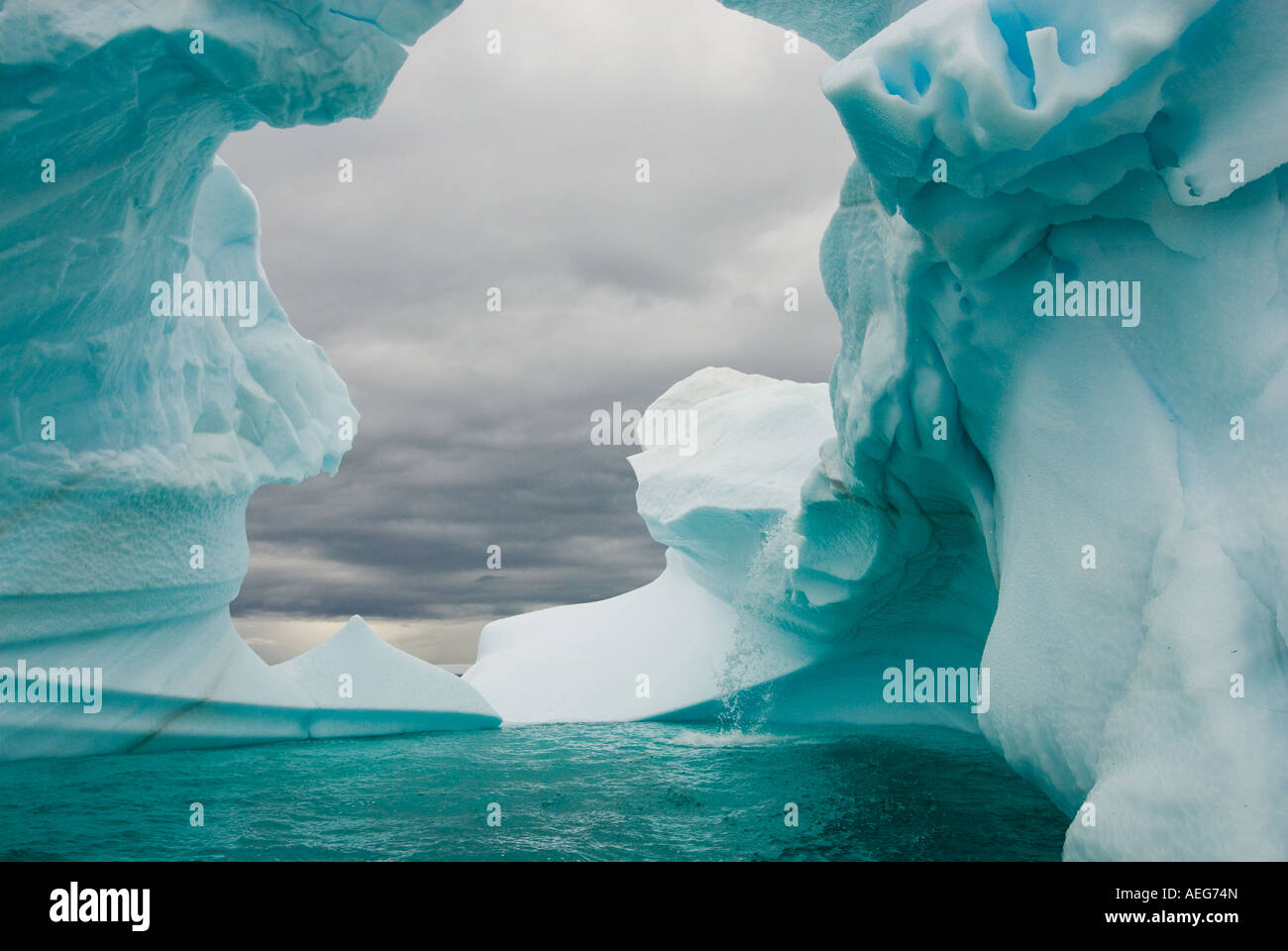 Arched Iceberg Floating Off The Western Antarctic Peninsula Antarctica arched-iceberg-floating-off-the-western-antarctic-peninsula-antarctica