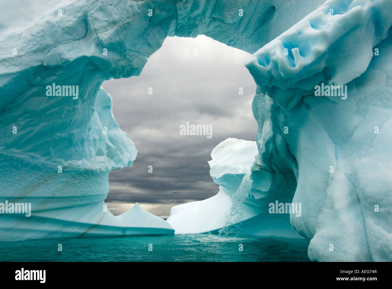 Arched Iceberg Floating Off The Western Antarctic Peninsula Antarctica arched-iceberg-floating-off-the-western-antarctic-peninsula-antarctica