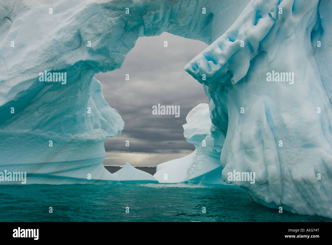 Arched Iceberg Floating Off The Western Antarctic Peninsula Antarctica arched-iceberg-floating-off-the-western-antarctic-peninsula-antarctica