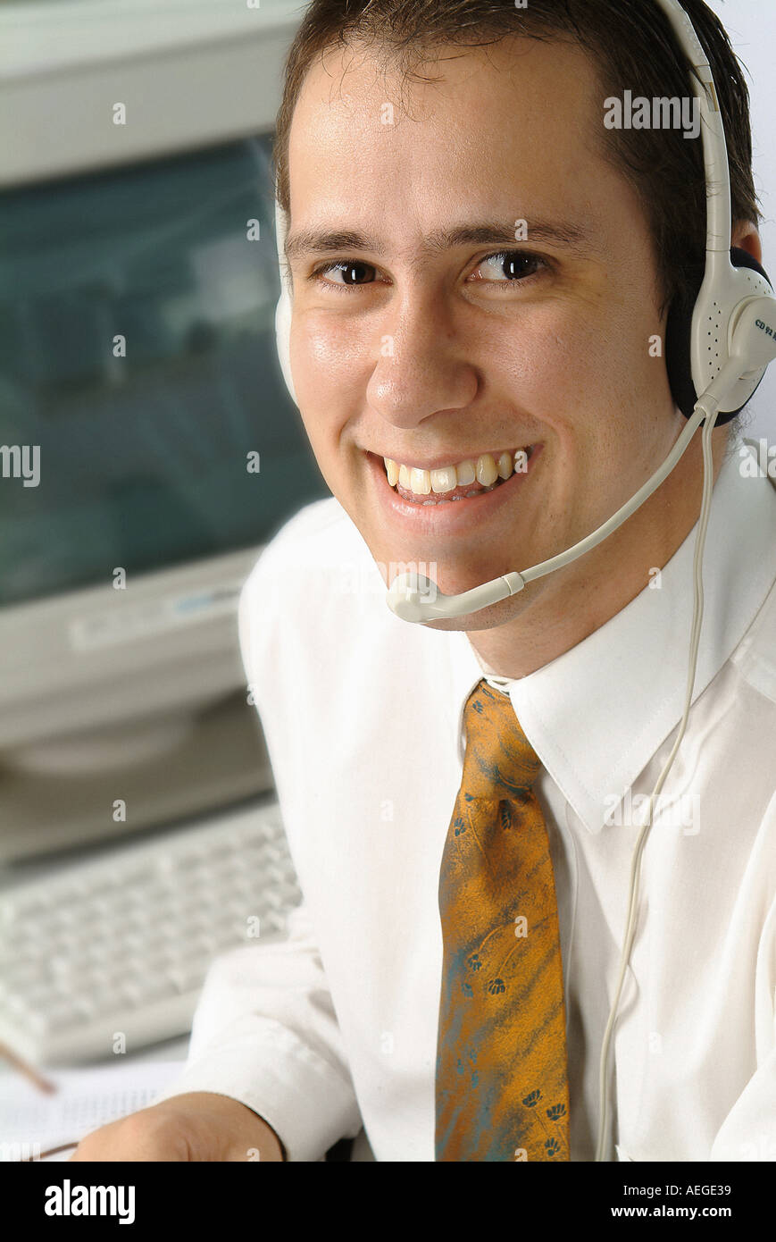 Businessman headset microphone glasses profile operator handsfree shirt tie smile smiling welcoming staring male person man peop Stock Photo