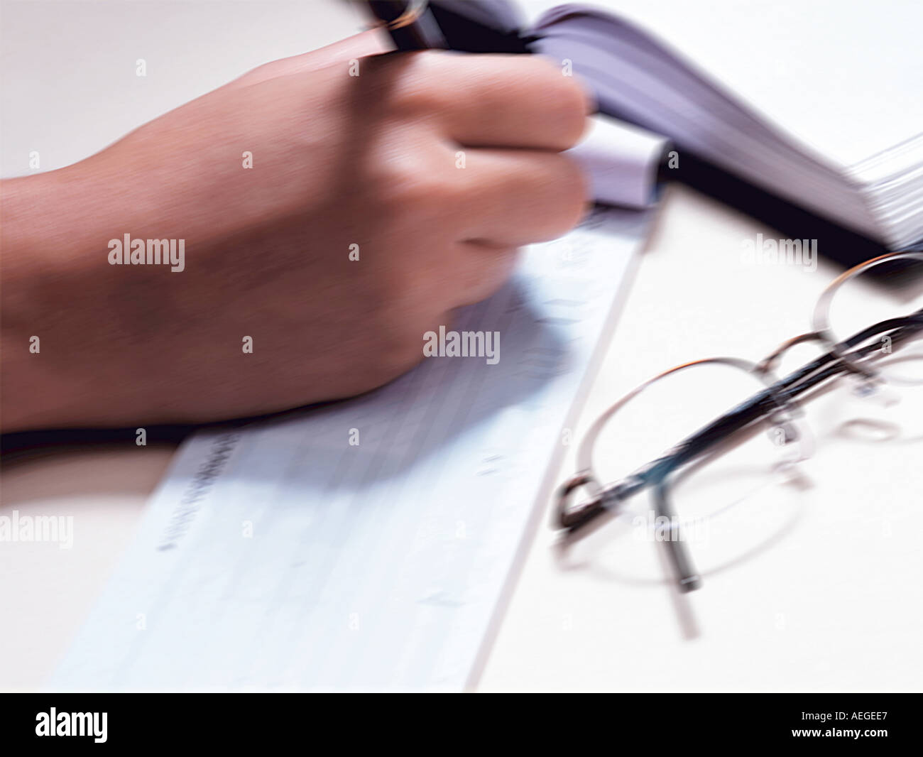 Office check checkbook filling out making writing payment order glasses spectacles appointment calendar hand pen blurred miscell Stock Photo