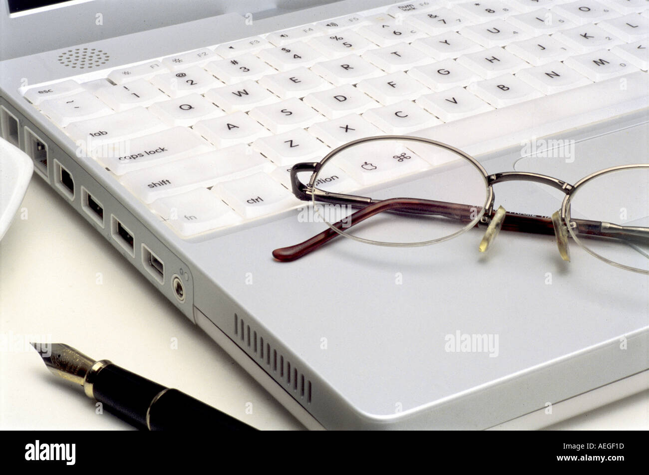 Office laptop detail fountain pen glasses spectacles keyboard keys technology computer business concept Stock Photo