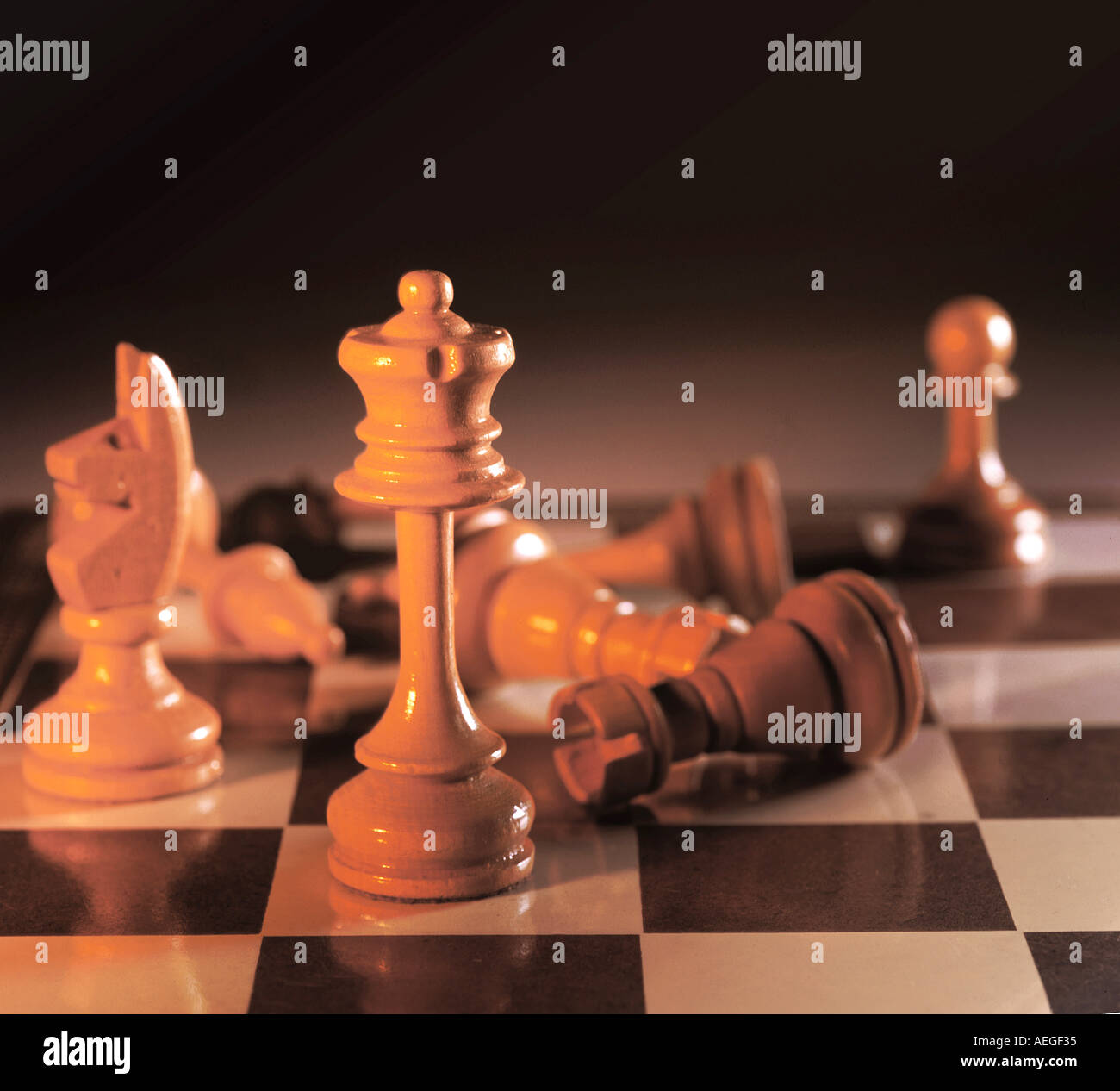 Office chess chessboard playing pieces wooden queen knight tower pawn leisure game miscellaneous background texture Stock Photo