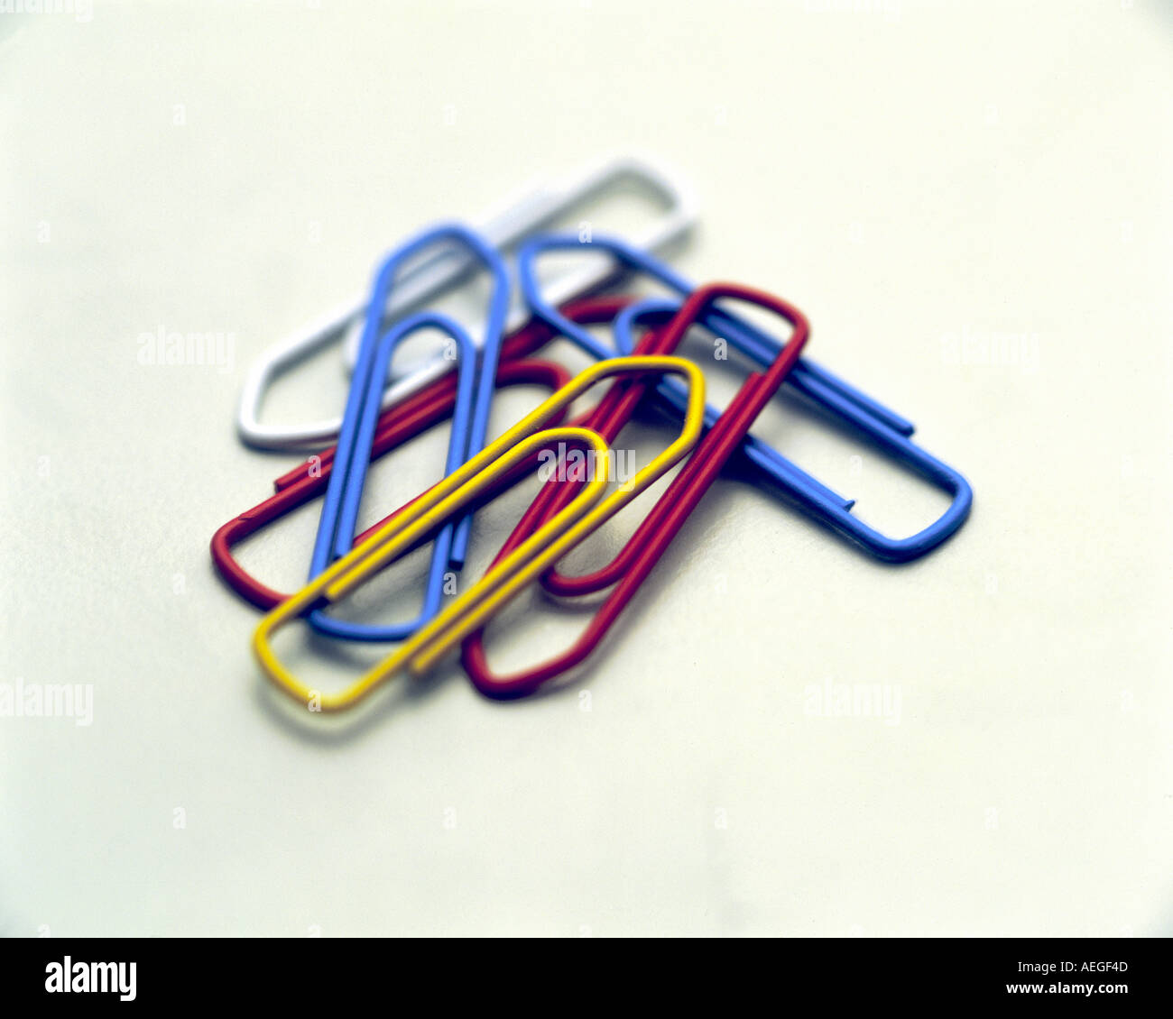 Office paperclip paperclips clip clips stationery blue red yellow white conceptual services business concept Stock Photo