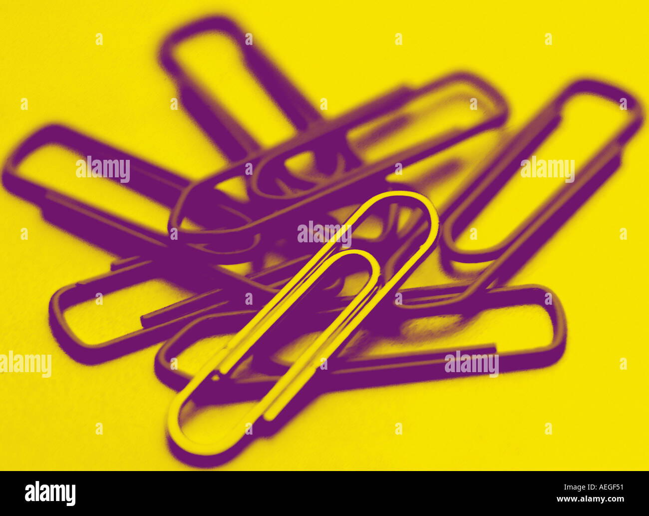 indoors paperclips paperclip metallic few contrasty yellow red stationery business concept conceptual services Stock Photo