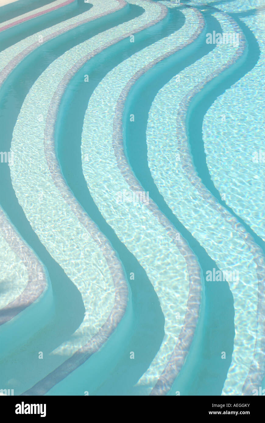 Contemporary patterned bold image of swimming pool steps seen above the water Stock Photo
