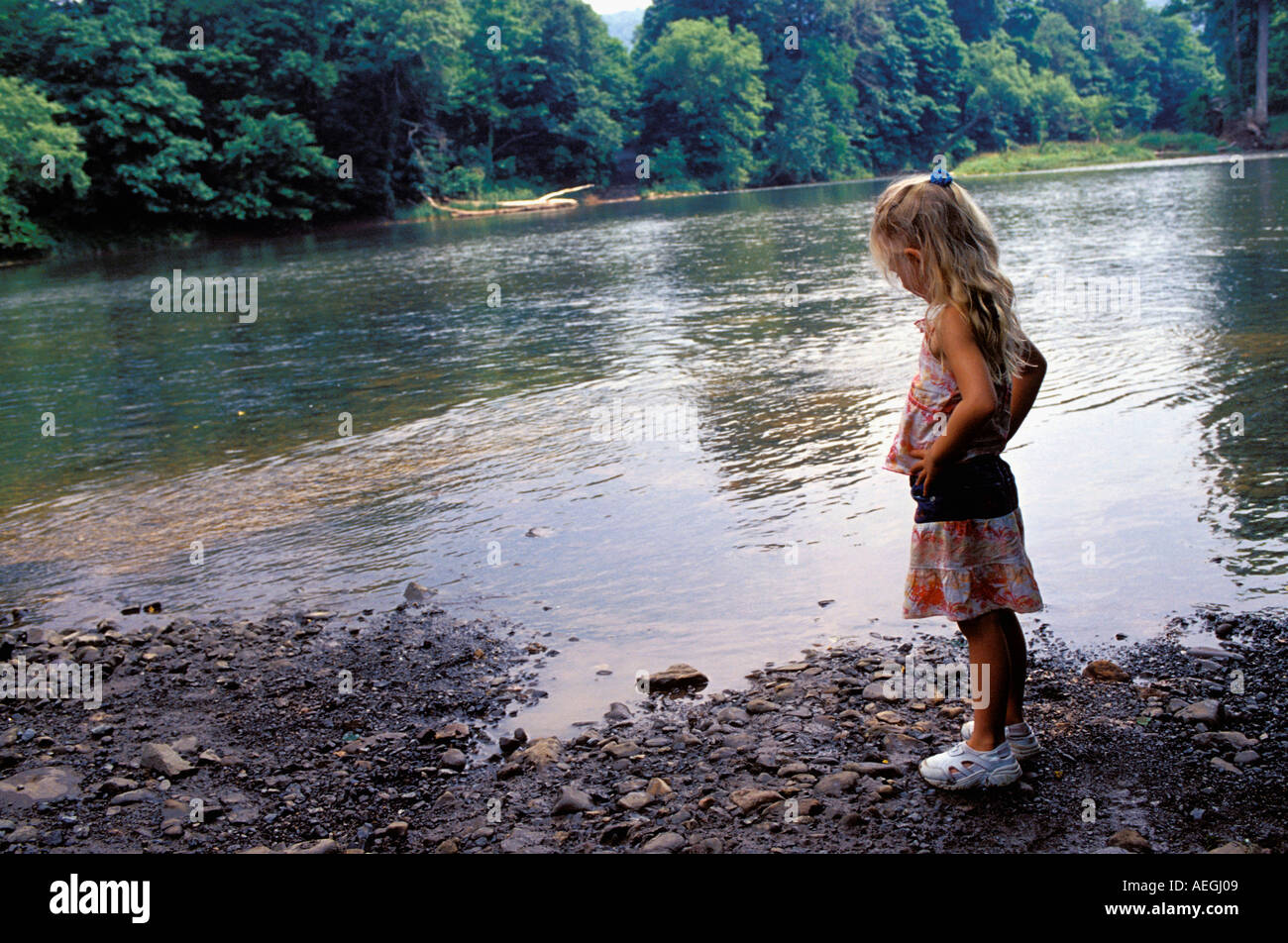 Little Girl Standing by River Stock Photo - Alamy