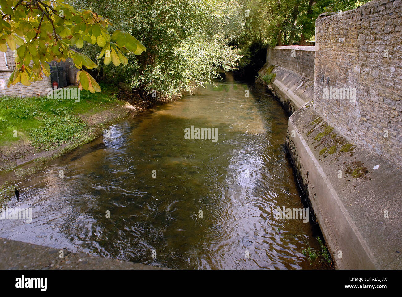 The River Thames flowing through the village of Kempsford Gloucestershire Stock Photo