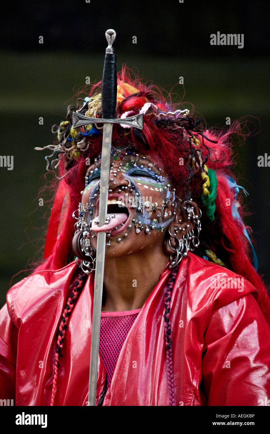 The worlds most pierced woman at the Edinburgh festival fringe Royal Mile with a sword inserted through her tongue, Scotland. Stock Photo