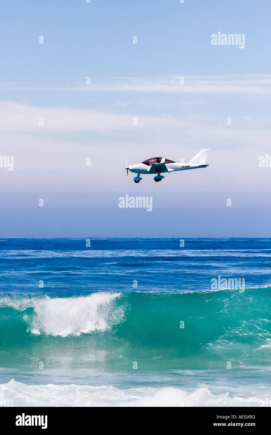 small plane flying on the ocean Stock Photo Alamy
