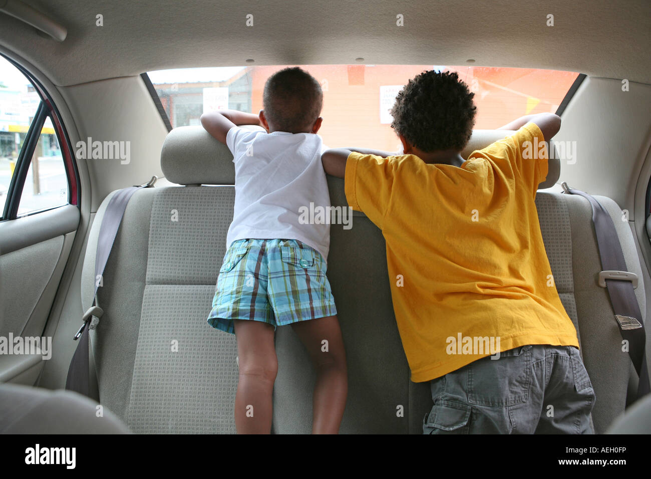 Children in back of car boy girl Young boy Stock Photo