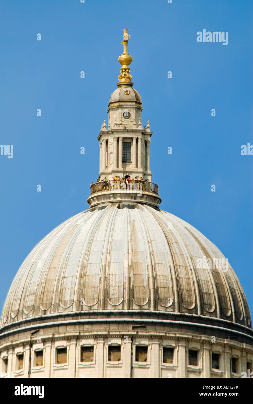 Vertical close up of Saint Paul's Cathedral and the dome with tourists at the top in the Golden