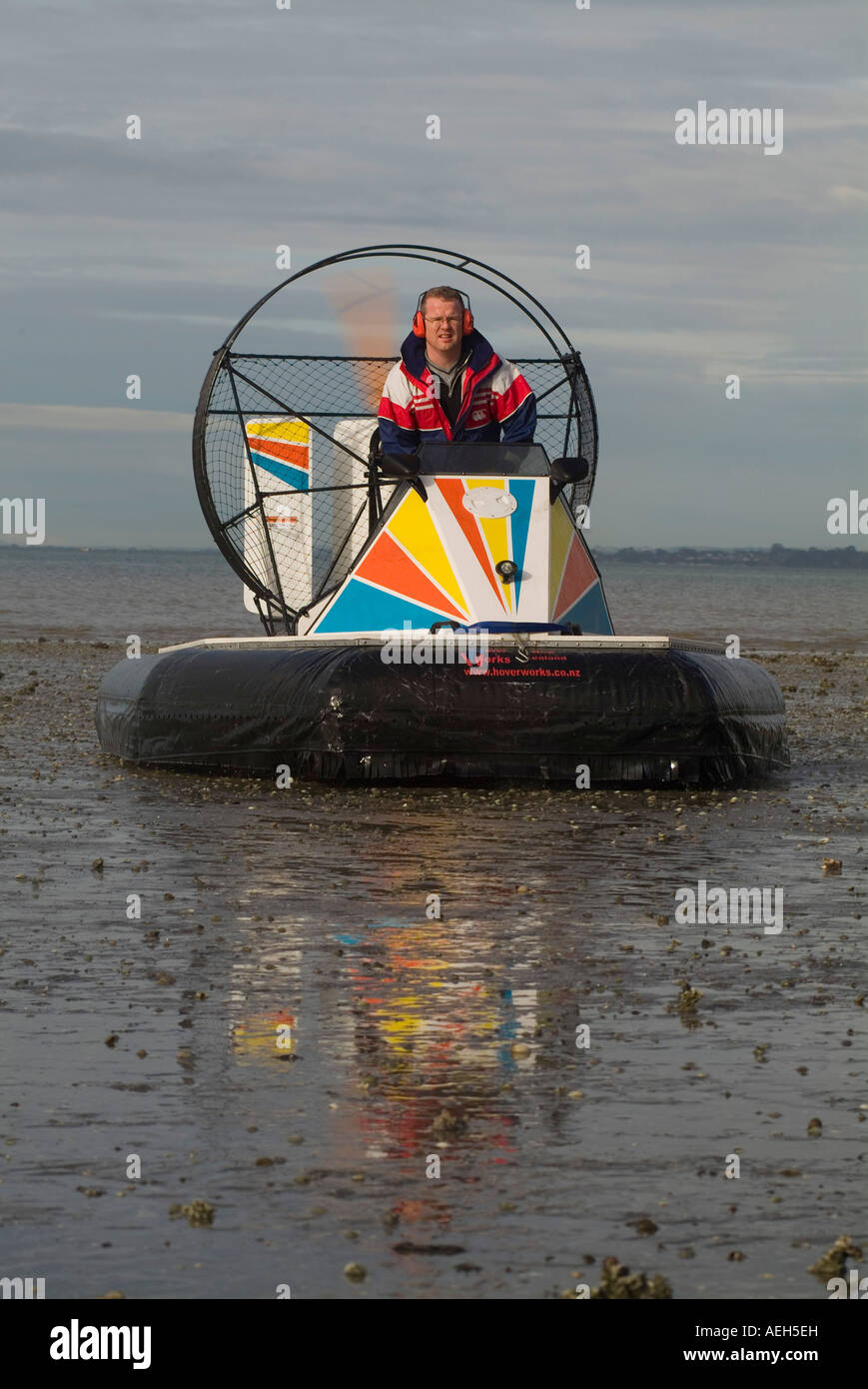 White caucasian male age 38 on www Hoverworks co nz hovercraft at French Bay Auckland NZ The vessel is on mud flats Stock Photo