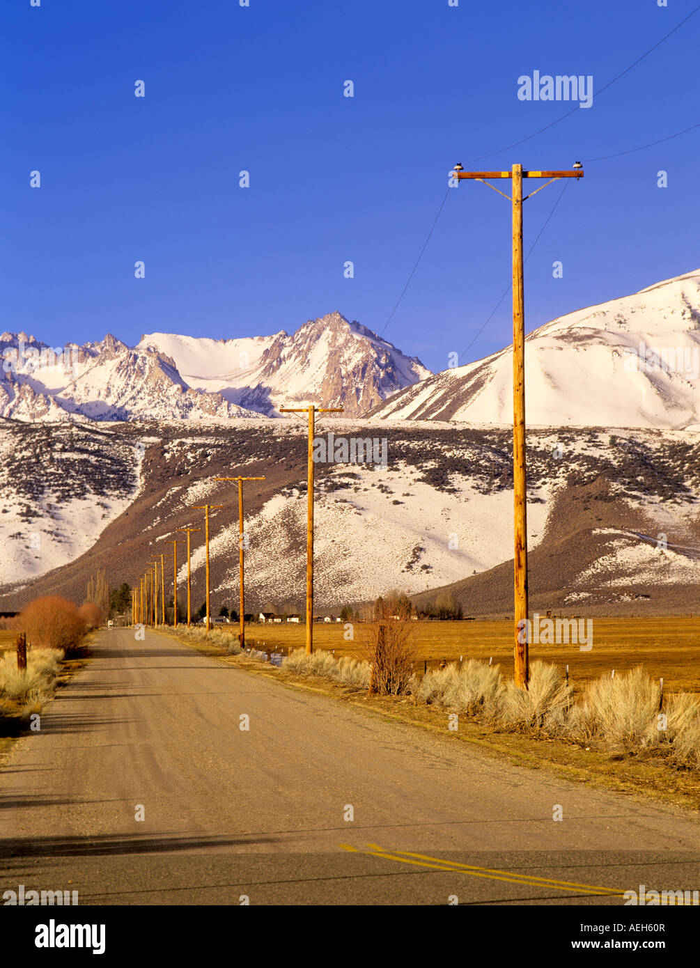 Road with power lines and Eastern Sierra Mountains California Stock Photo