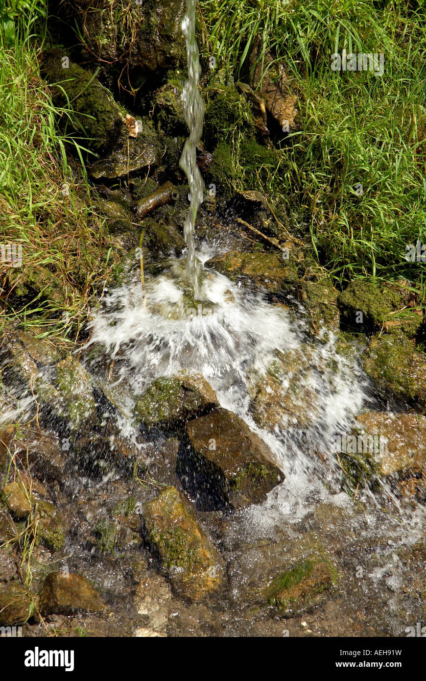 Stream of Water falling into a rocky stream bed Stock Photo