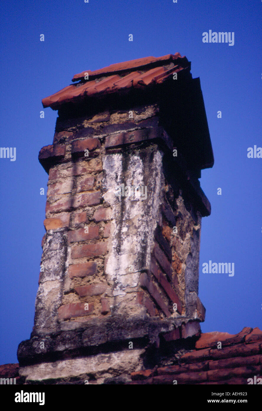 old dilapidated chimney on rooftop of a farmhouse. Photo by Willy Matheisl Stock Photo