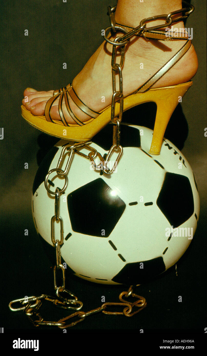 girls leg chained to a  soccer ball. Photo by Willy Matheisl Stock Photo