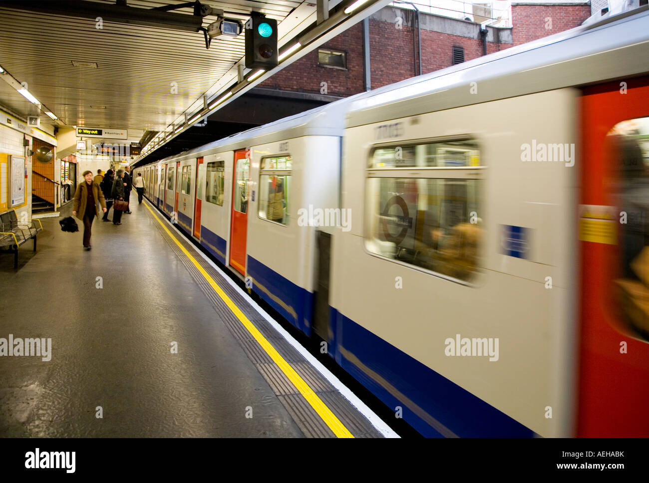 Underground train leaving platform green go signal Stock Photo