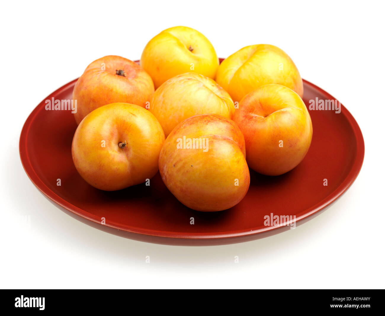 Fresh Ripe Healthy Juicy Sweet Yellow Stone Fruit Plums Isolated Against A White Background With No People And A Clipping Path Stock Photo