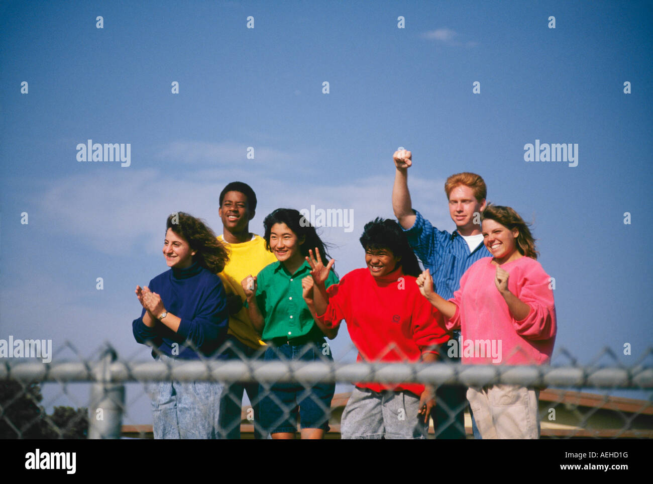 young person people Racially mixed ethnically ethnic racial diverse boys girls  hanging out cheering team sporting event game jumping happy cheer © == Stock Photo