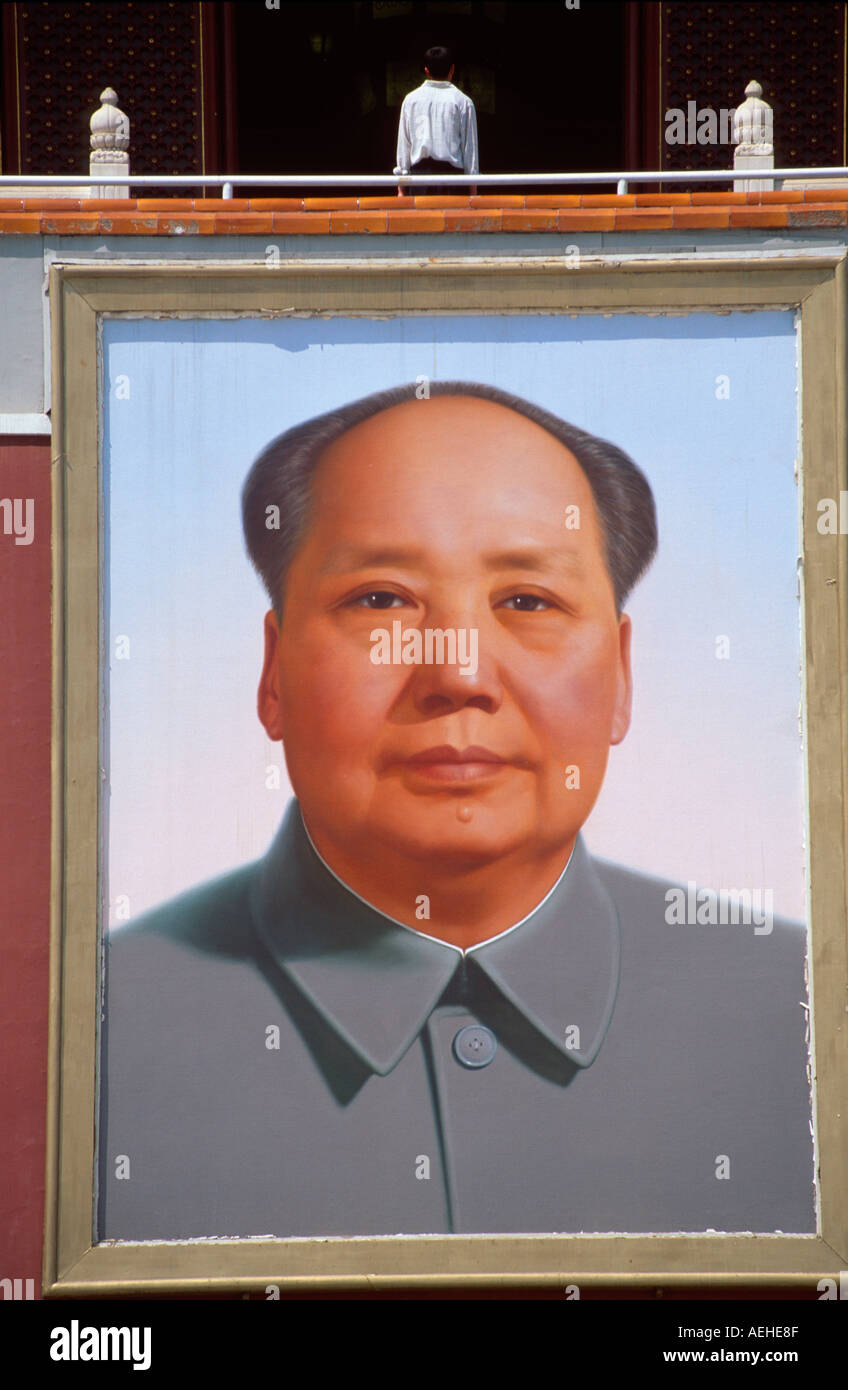 Man standing above giant portrait of Chairman Mao on Tiananmen Gate, Tiananmen Square, Beijing, China Stock Photo