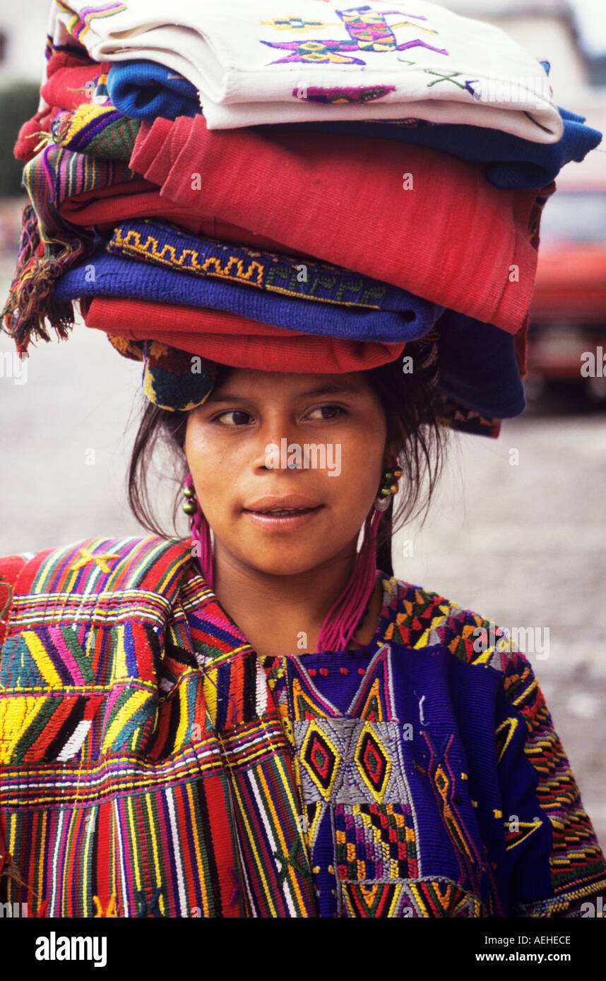 Guatemala Antigua young lady selling and woven tunics hupils Stock Photo