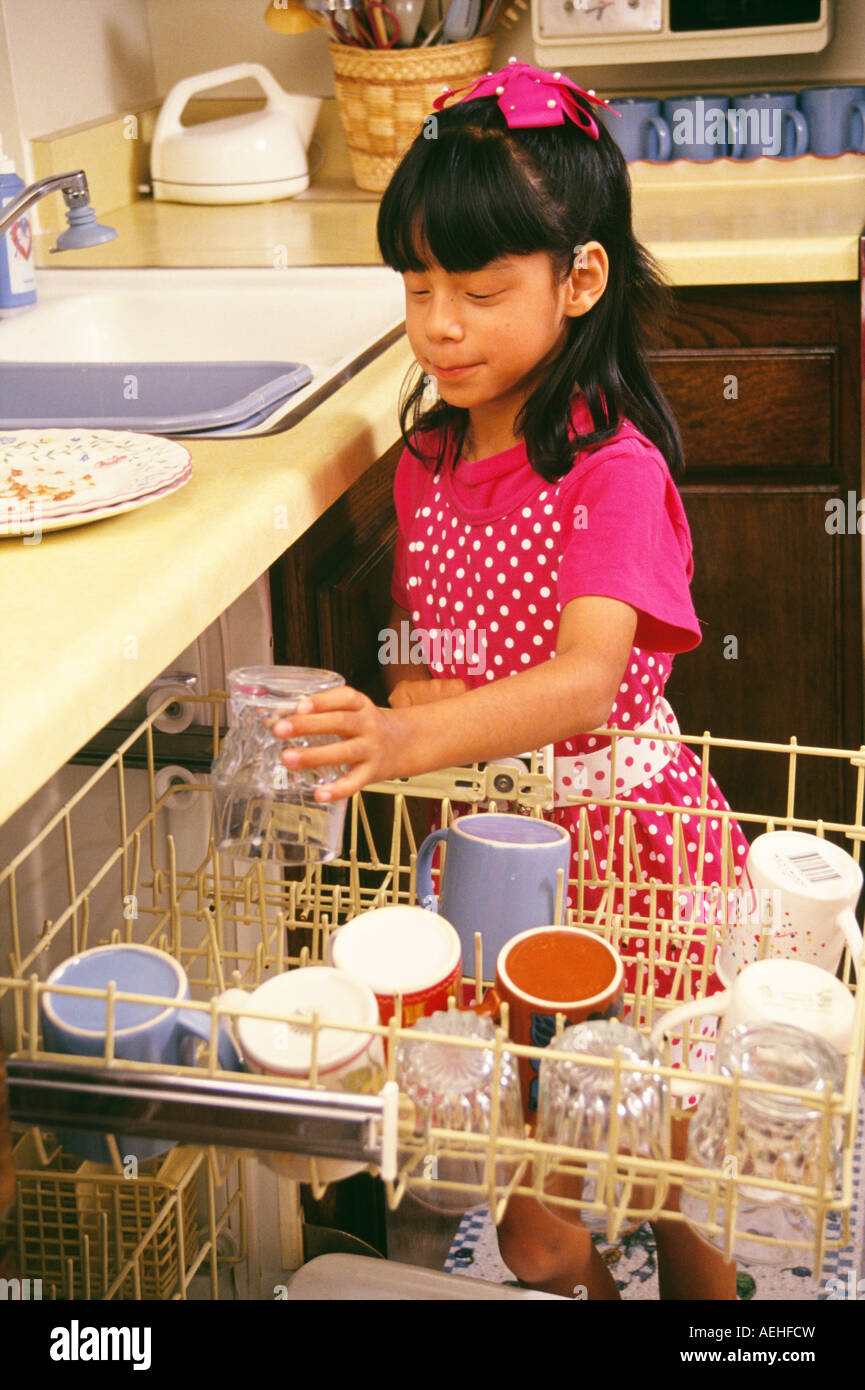 Ethnic minority Girl helping chores  cleaning kitchen loading dishwasher for mother United States ©Myrleen Pearson Stock Photo