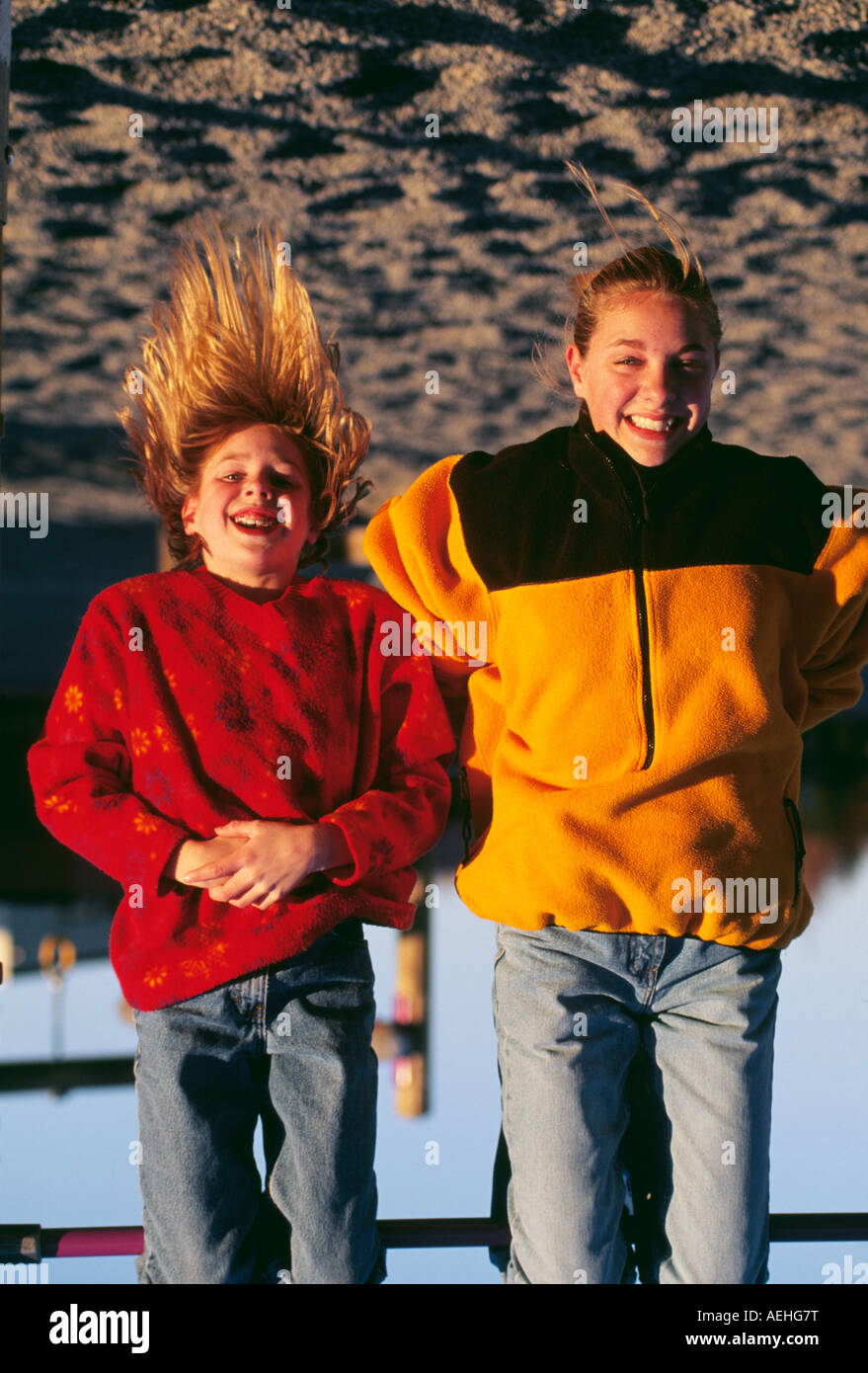 Young woman with girl smiling Stock Photo