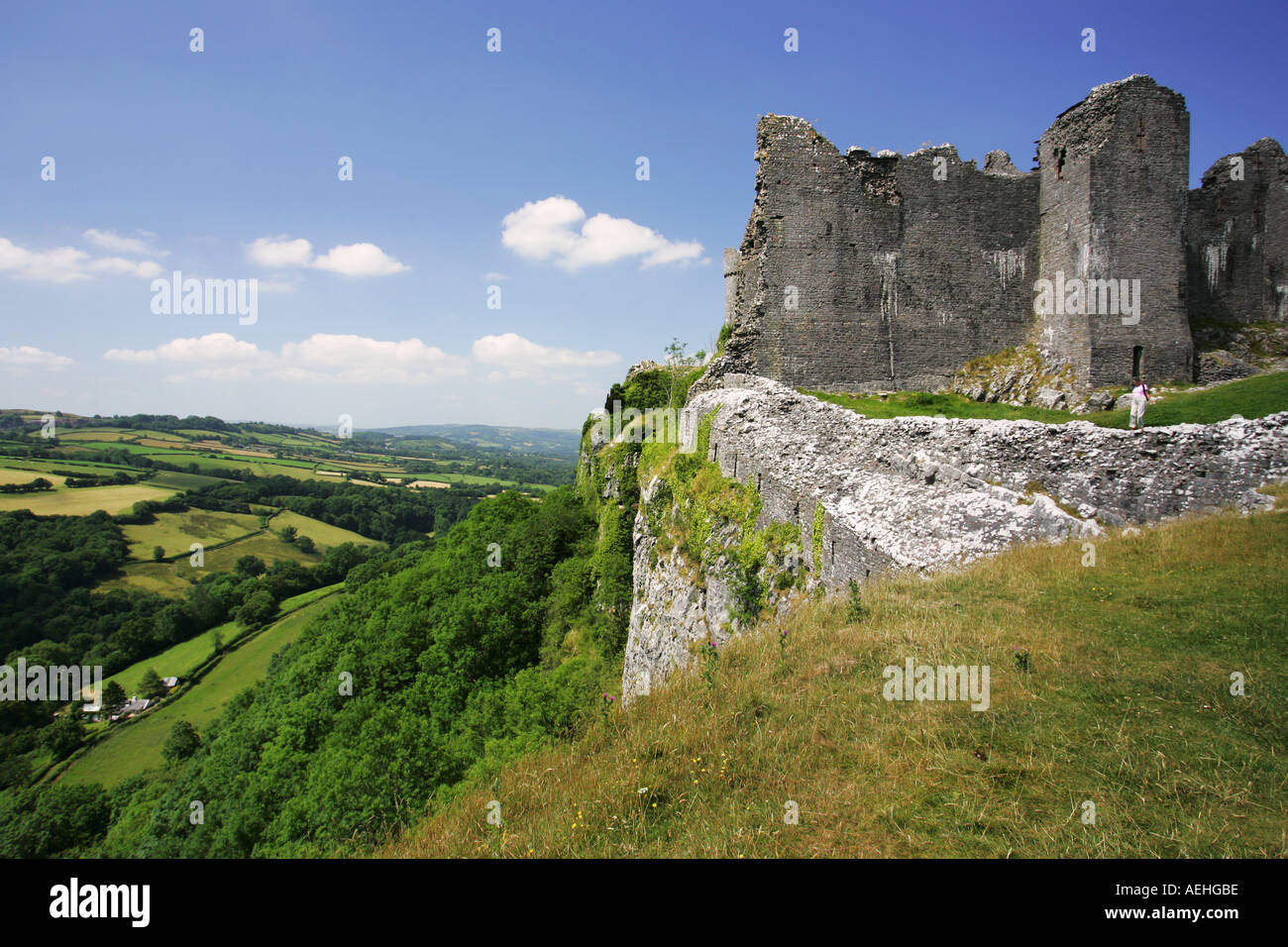 Side view of Carreg Cennen castle and the vast drop into the lush green ...