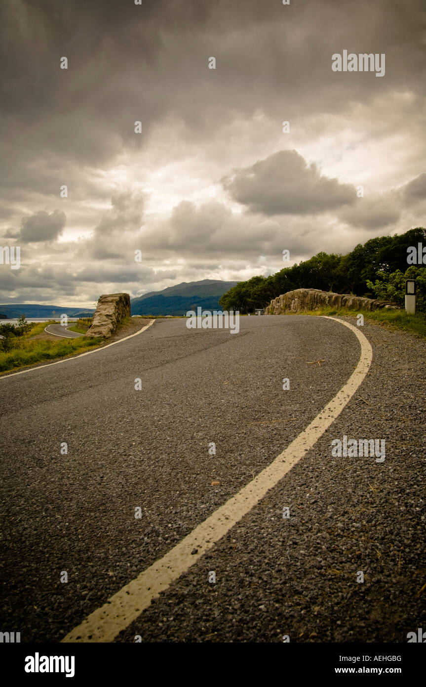 Road leading to hump backed bridge Stock Photo Alamy