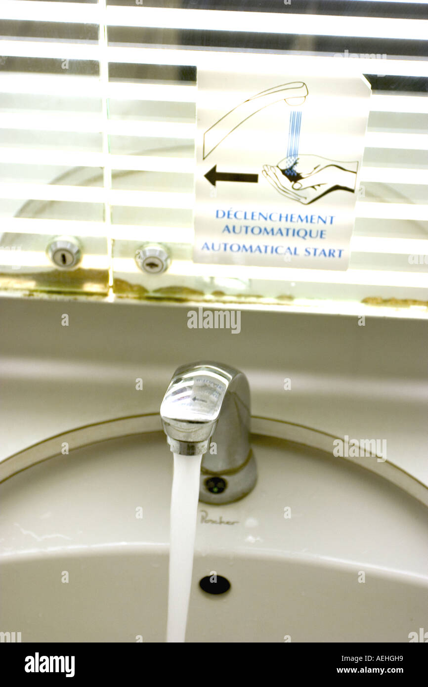 bathroom water tap with running water Stock Photo Alamy