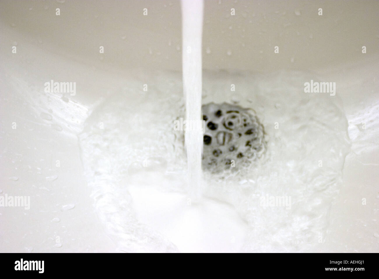 bathroom water tap with running water Stock Photo Alamy