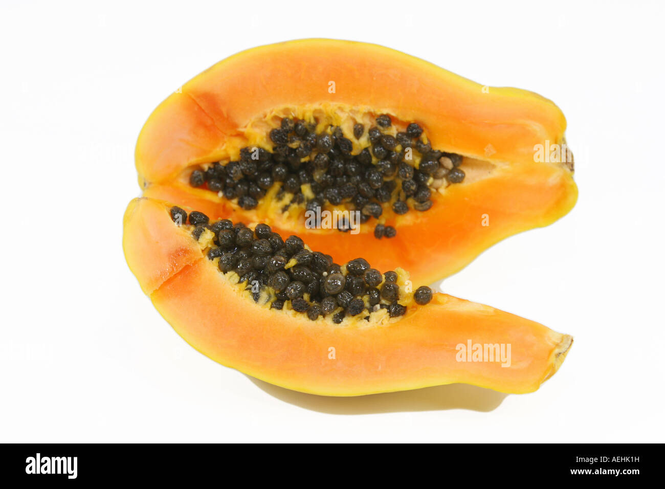 open papaya with seeds and pulp isolated over white Stock Photo Alamy