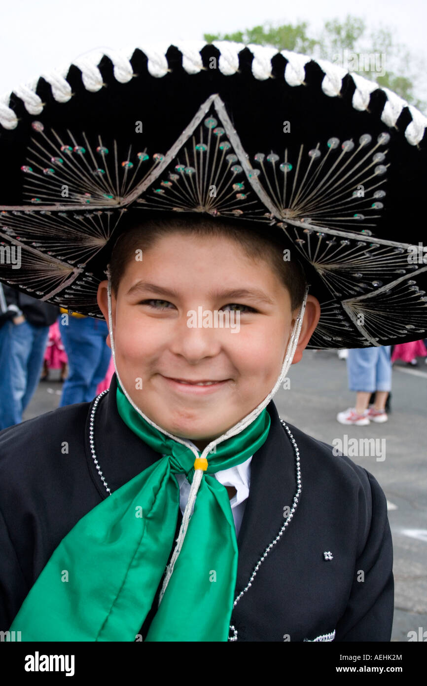 Happy Chicano boy age 10 dressed in Mexican sombrero and outfit for the parade. Cinco de Mayo Fiesta. 'St Paul' Minnesota USA Stock Photo